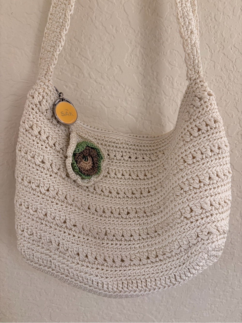The Sak Cream Crochet Shoulder Bag with Green-Brown Flower